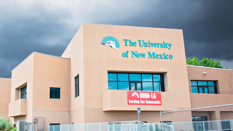 adobe building with the words university of new mexico on the side