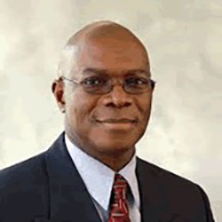 Sam Dosumu, adult black male wearing oval rimmed glasses