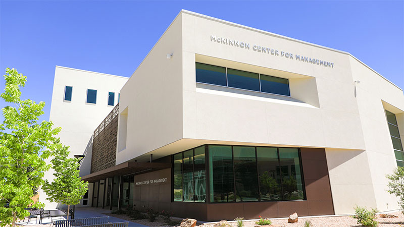 modern stucco building exterior with the words Mckinnon center for management
